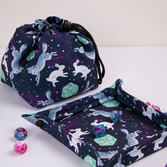 Handmade dice bag wolf and rabbit, perfect for dnd christmas gifts and dungeons and dragons christmas gifts. Features 6 interior pockets, cotton lining, and durable gabardine exterior. Freestanding 5" square base and 7" height with secure drawstring closure. Large RPG pouch ideal for dice storage, tokens, and miniatures. Eco-friendly packaging makes it gift-ready for tabletop gamers and Dungeon Masters.