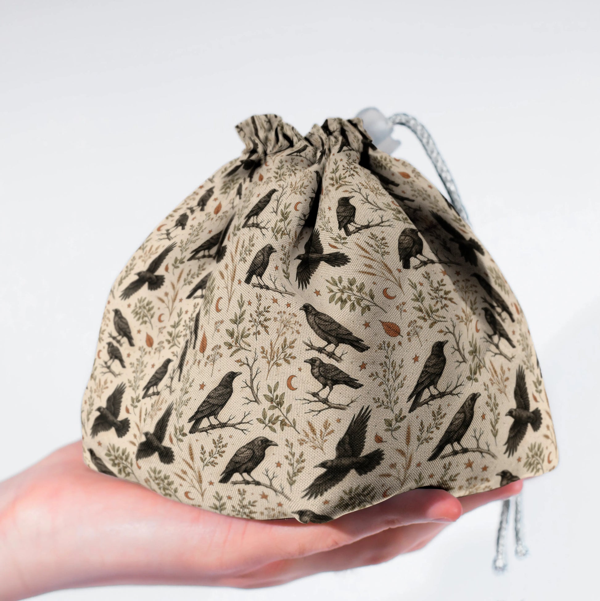 Handmade crow dice bag — a flock of black crows and stars on cream, a 6-pocket dark academia organizer.