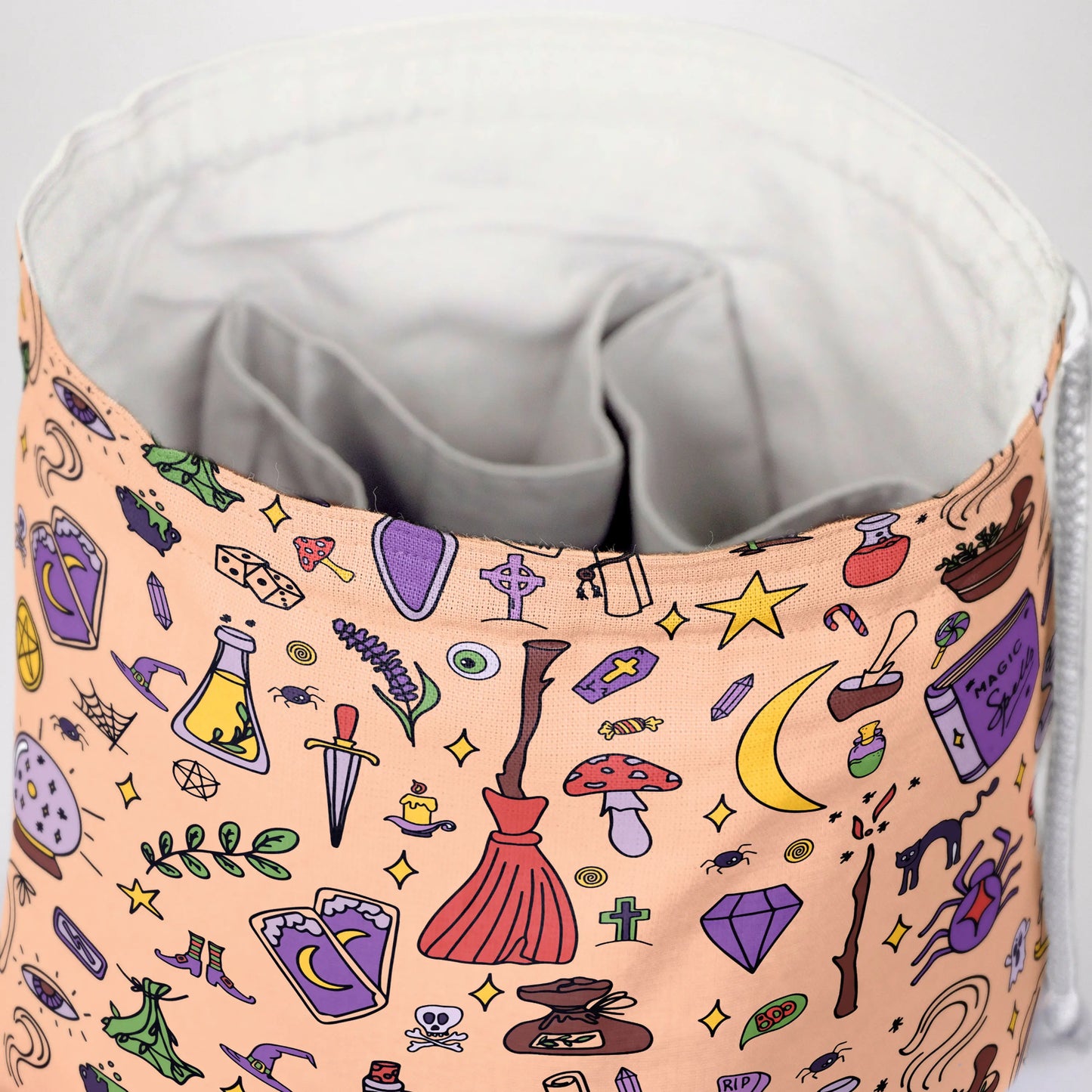 Witchy doodle dice bag with 6 pockets — sorts dice sets for a witchy table.