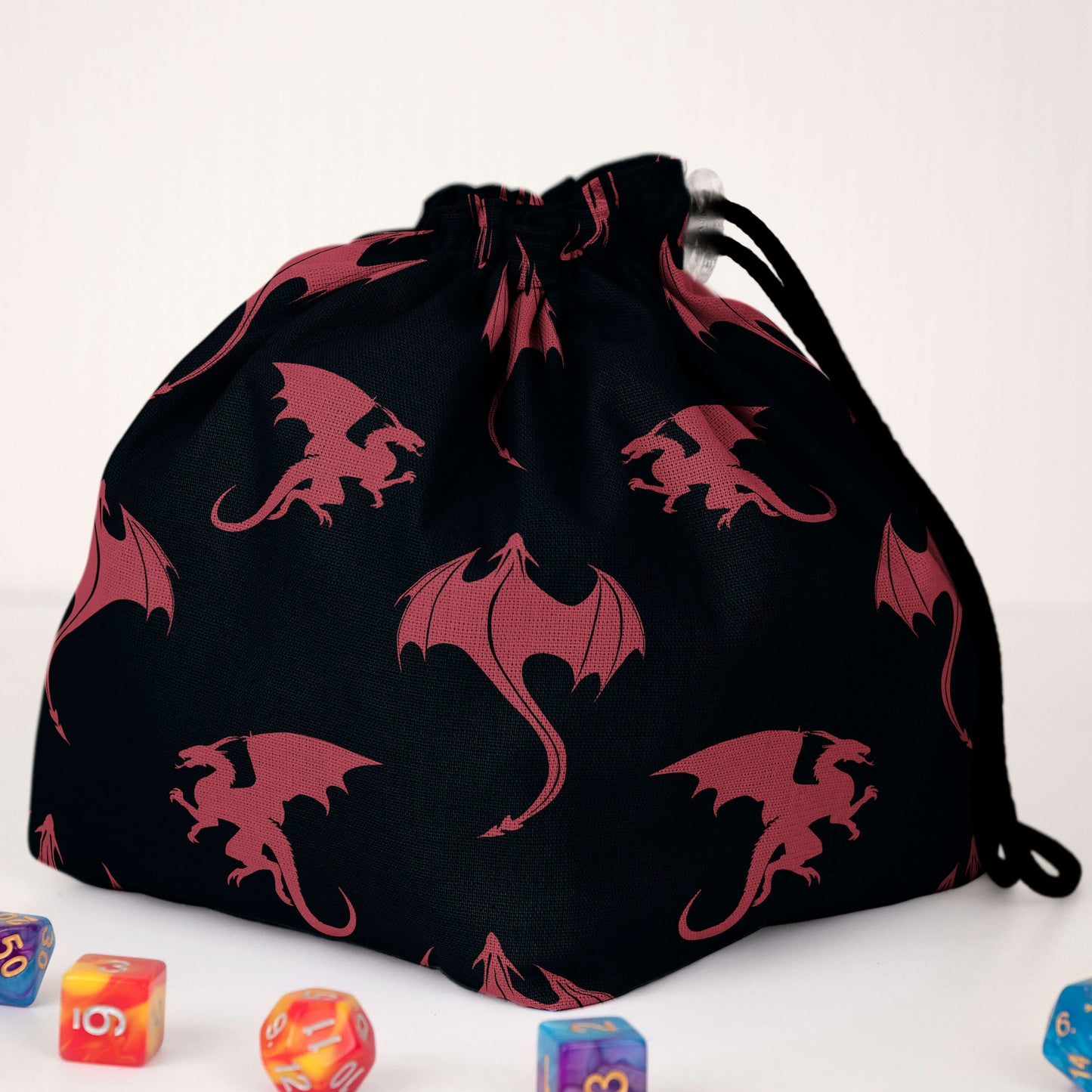 Navy dragon-silhouette dice bag standing upright on its square base.