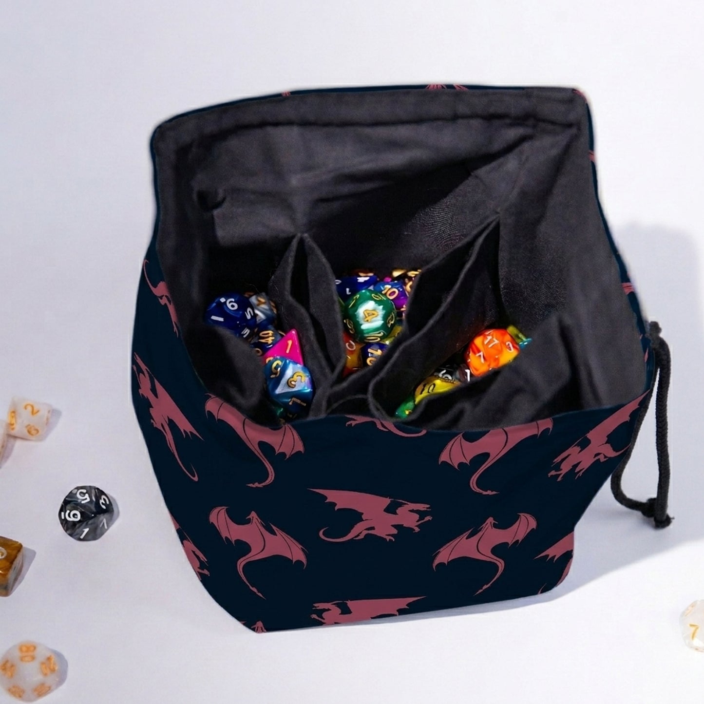 Handmade navy dragon dice bag open to show pockets and dice — rose dragon silhouettes, 300+ capacity.