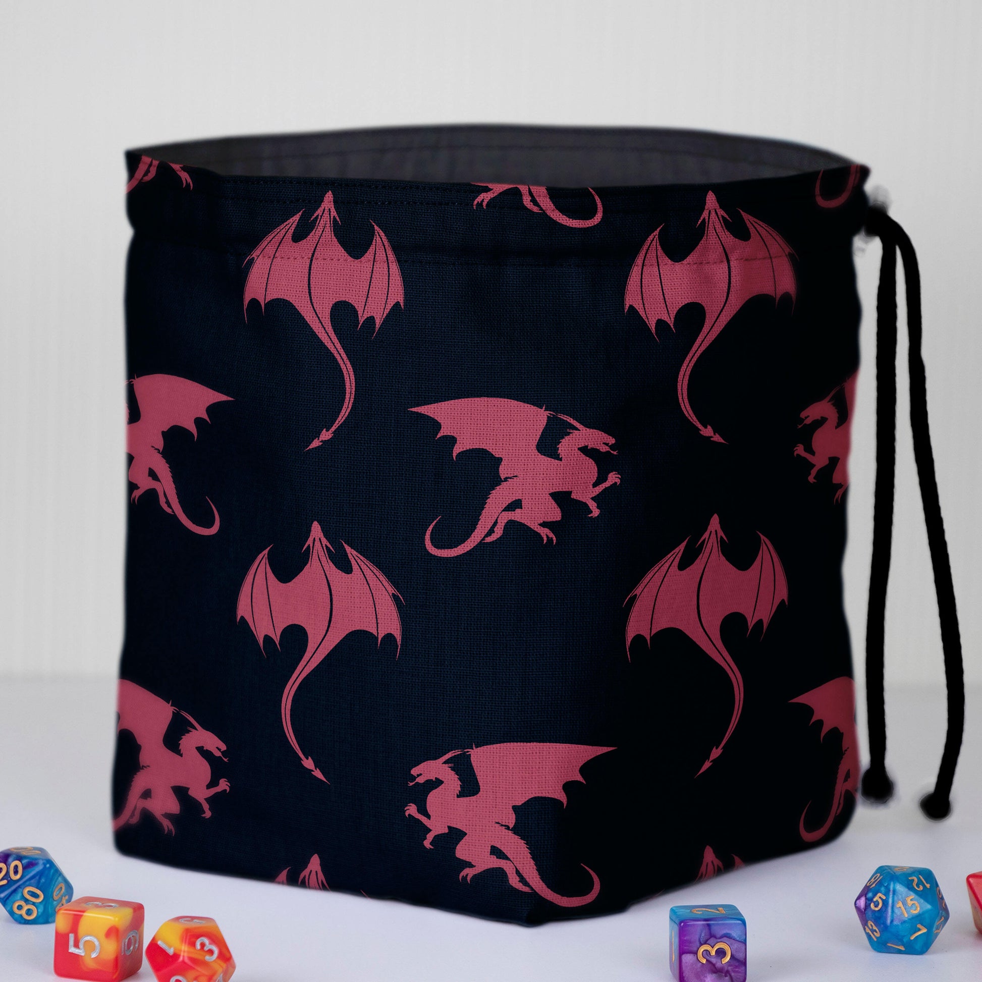 Close-up of the rose dragon silhouettes on navy fabric — handmade fantasy print.