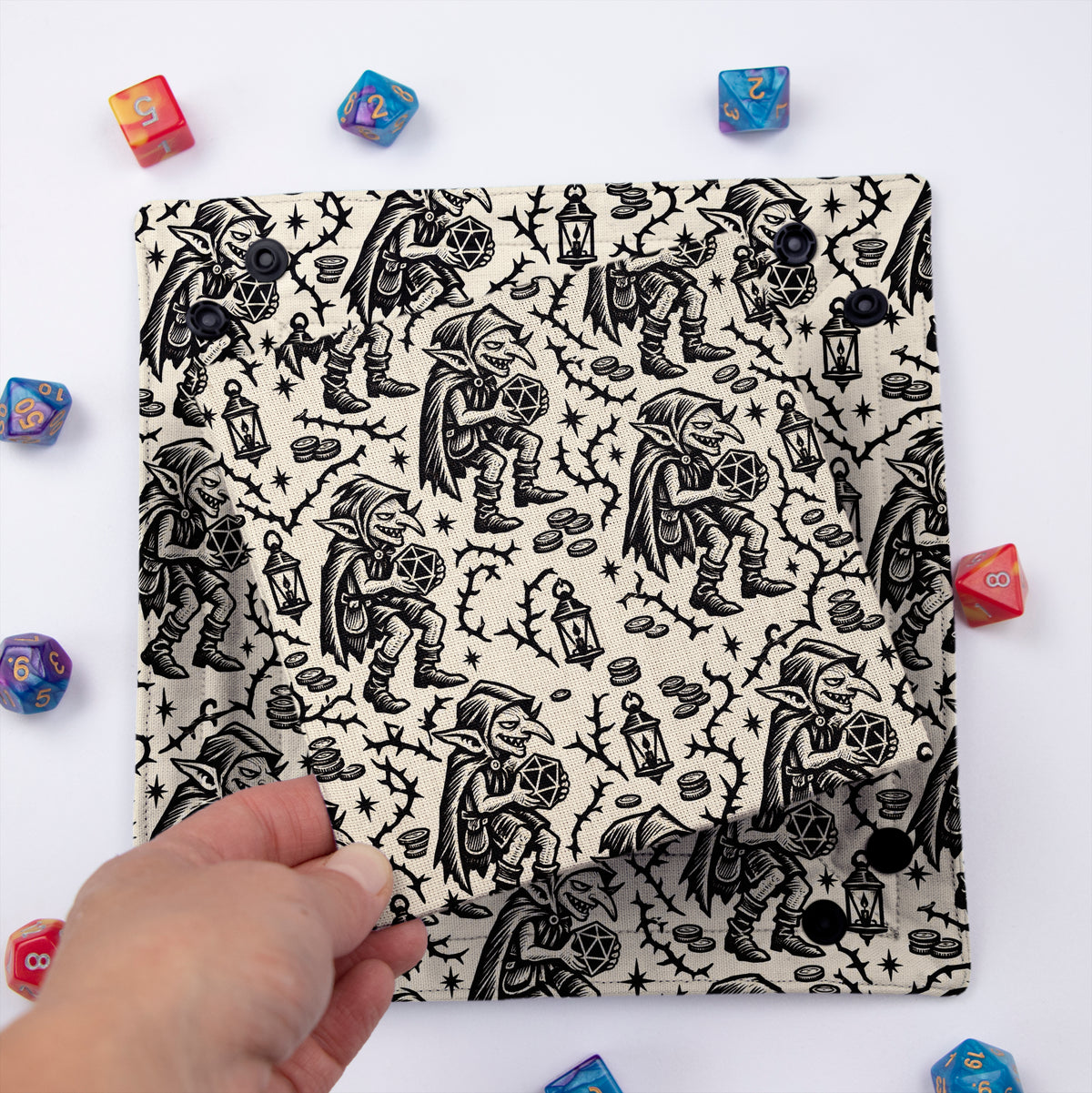 Goblin Woodcut dice tray folded flat with the removable hard insert lifted by hand