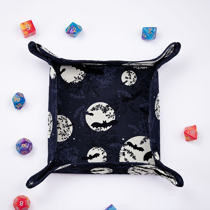 Bat dice tray from above, full moons and flying bats on the rolling surface