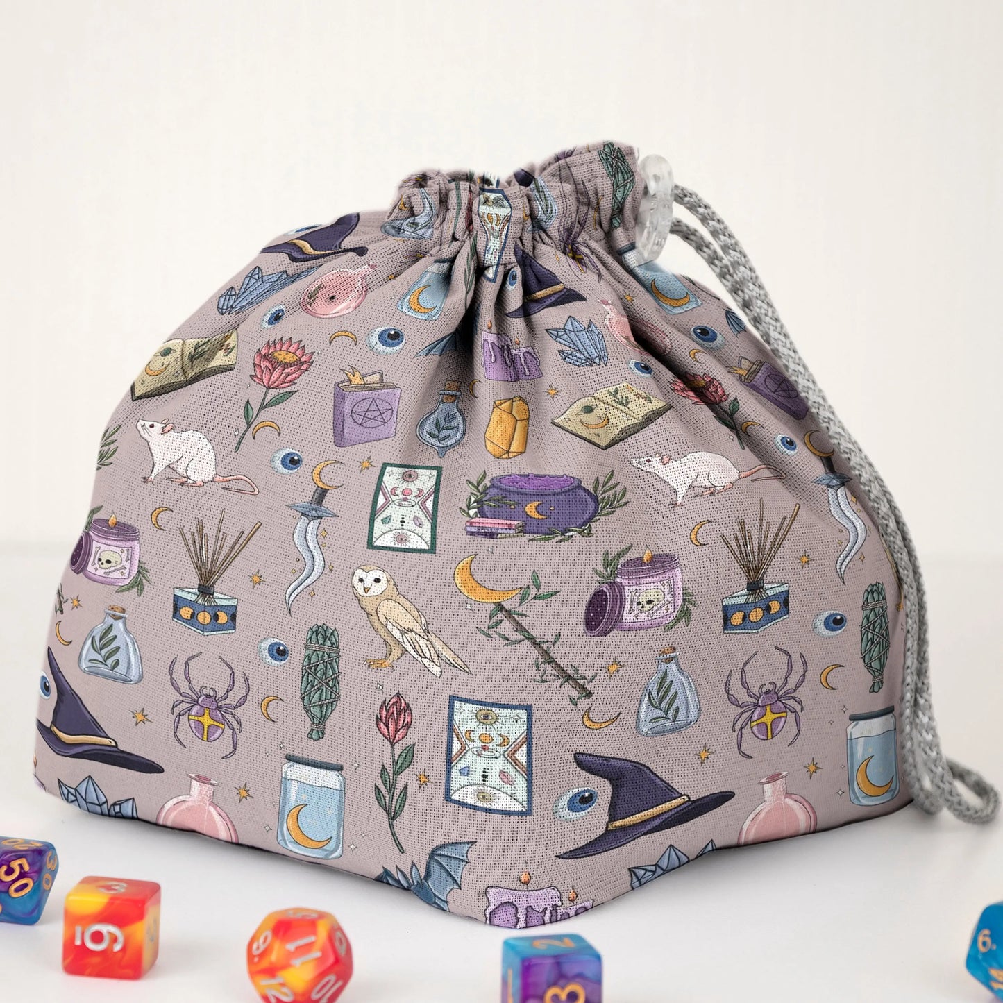 Pastel witch dice bag with 6 pockets — sorts dice sets for a witchy table.