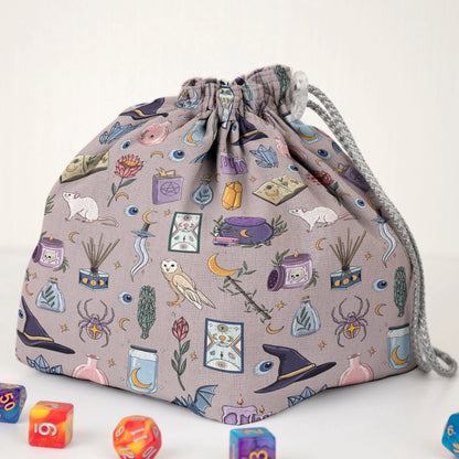 Pastel witch dice bag with 6 pockets — sorts dice sets for a witchy table.