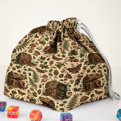 Botanical mimic dice bag print detail — treasure chests with teeth hidden among leaves