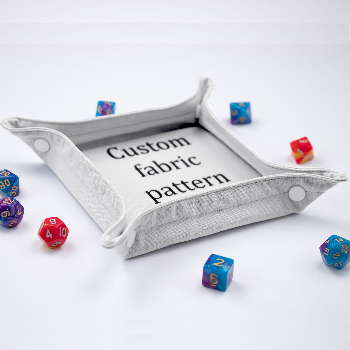 GameFancy custom printed dice tray: foldable fabric tray with snap-button corners, printed with your own image, shown with polyhedral dice.