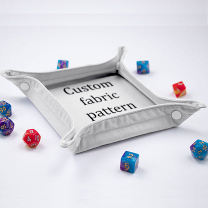 GameFancy custom printed dice tray: foldable fabric tray with snap-button corners, printed with your own image, shown with polyhedral dice.