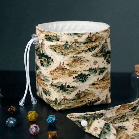Fantasy Map dice bag standing open beside its matching snap-corner dice tray, vintage map print with castles and mountains