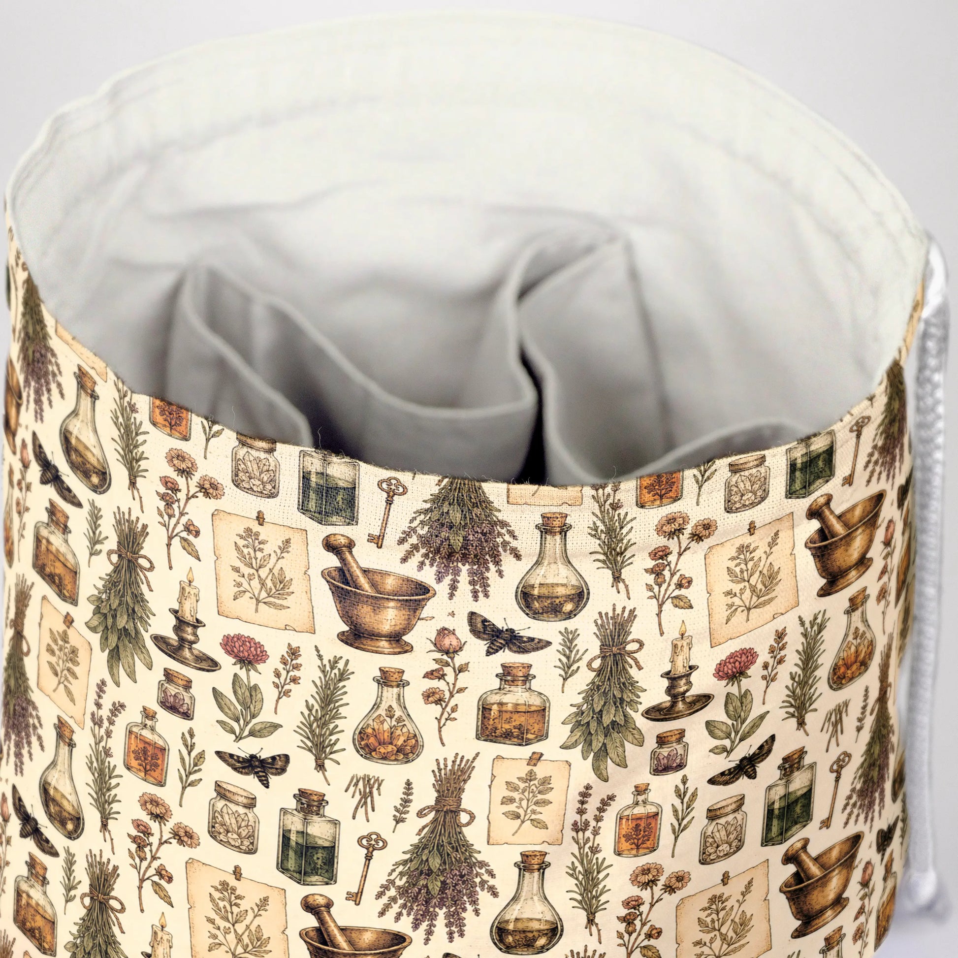 The Apothecary's Shelf dice bag front view with drawstring closure — witchy DnD pouch.