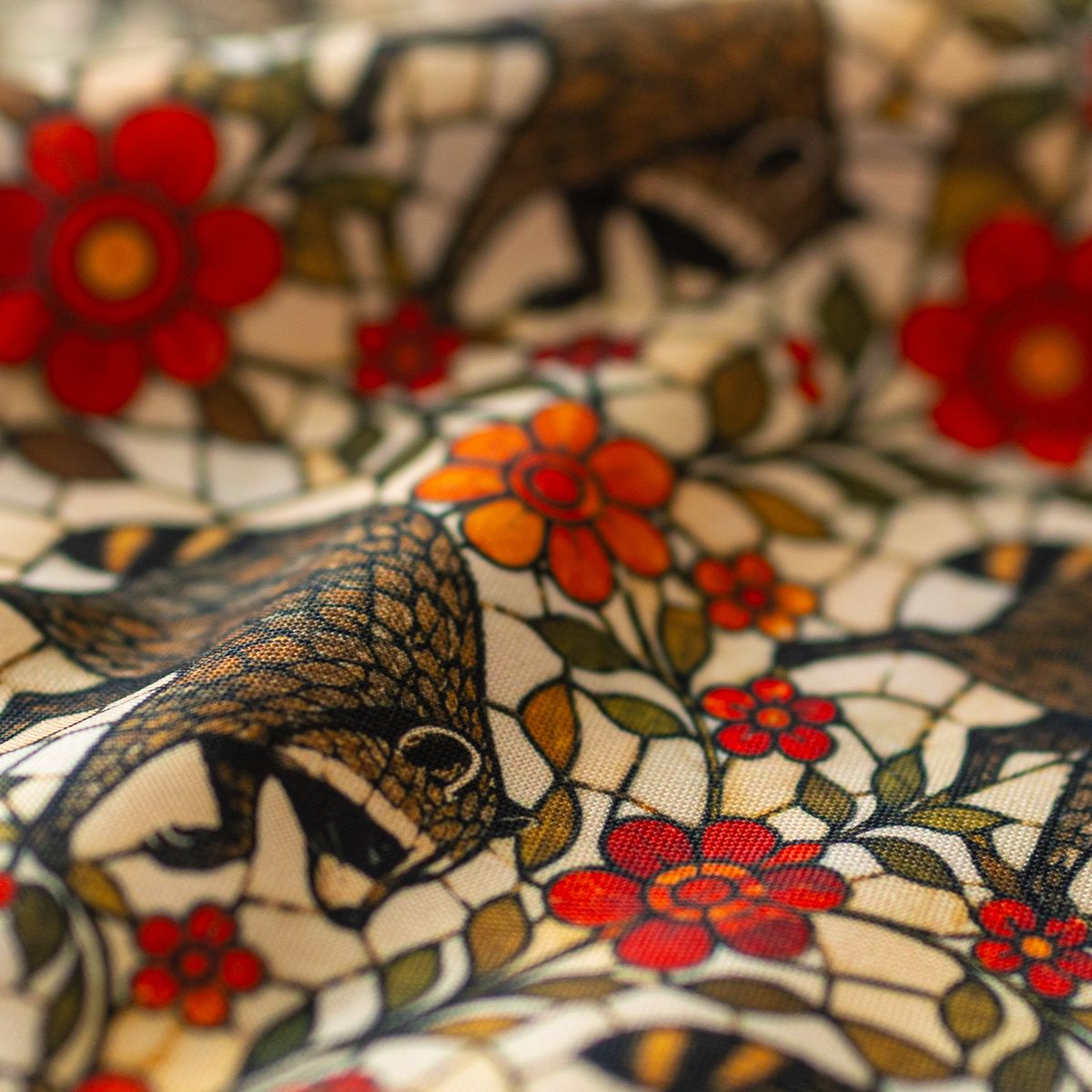 Close-up of GameFancy Jimothy stained glass garden print fabric, raccoons and red flowers, used for dice bags