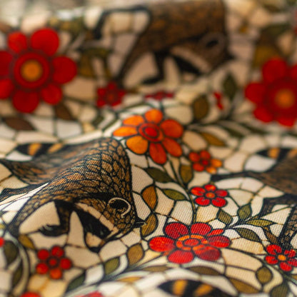 Close-up of GameFancy Jimothy stained glass garden print fabric, raccoons and red flowers, used for dice bags