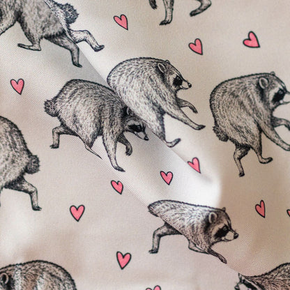 Close-up of GameFancy Jimothy raccoon print fabric, grey hearts design, used for handmade dice bags