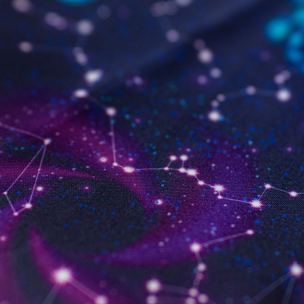 Close-up of GameFancy nebula print fabric, cosmic clouds and stars, used for handmade dice bags and trays