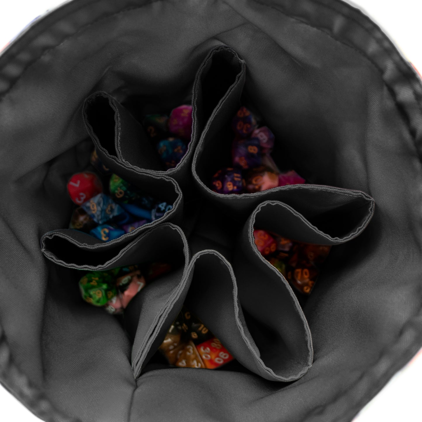 Open dice bag interior with six pockets full of colourful dice — handmade DnD organizer.