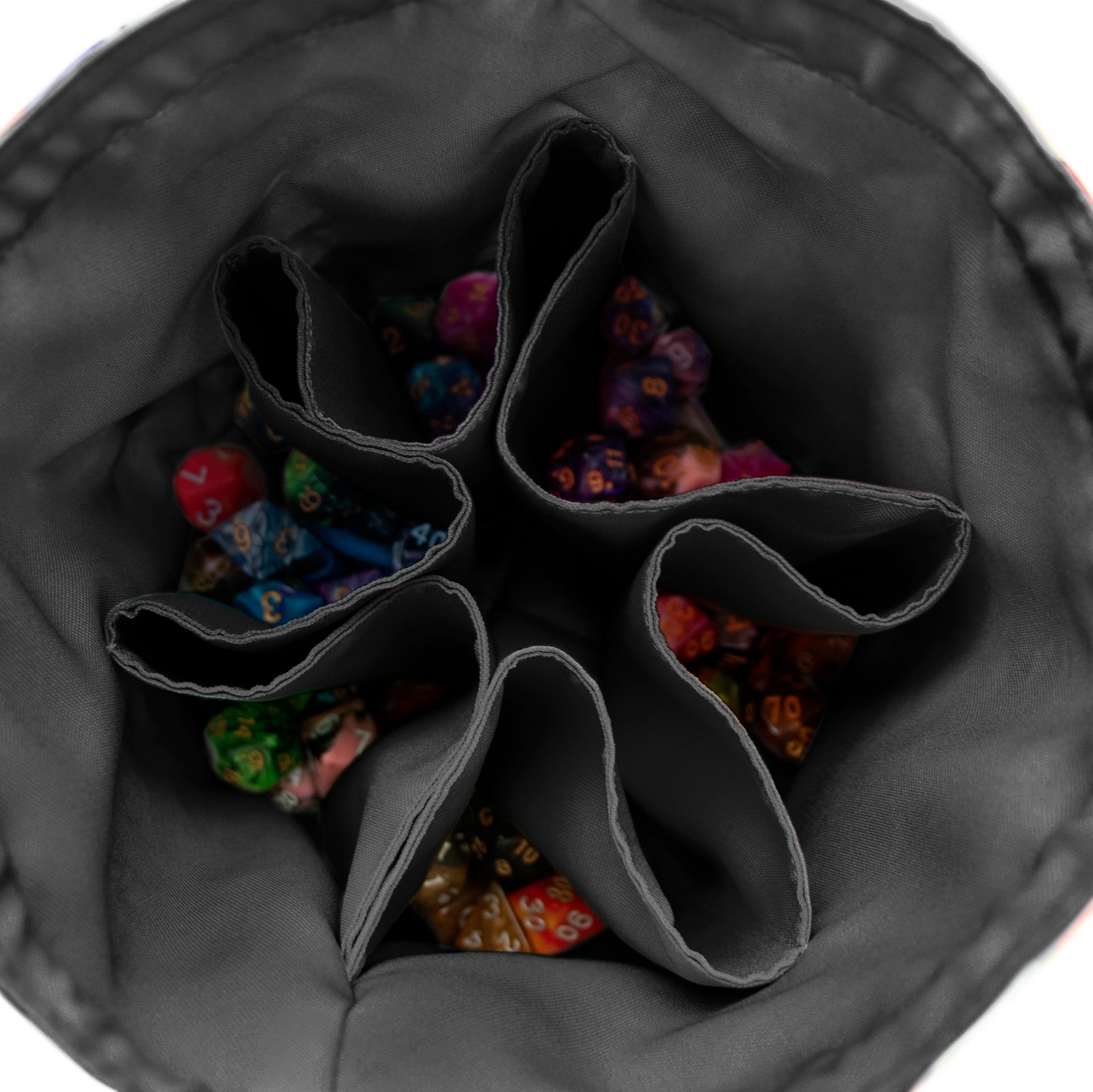 Open dice bag interior with six pockets full of colourful dice — handmade DnD organizer.