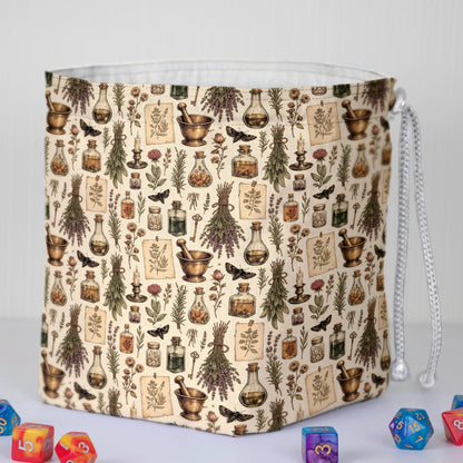 Handmade apothecary dice bag — herbs, jars and moths on cream, a 6-pocket witchy dark academia organizer.