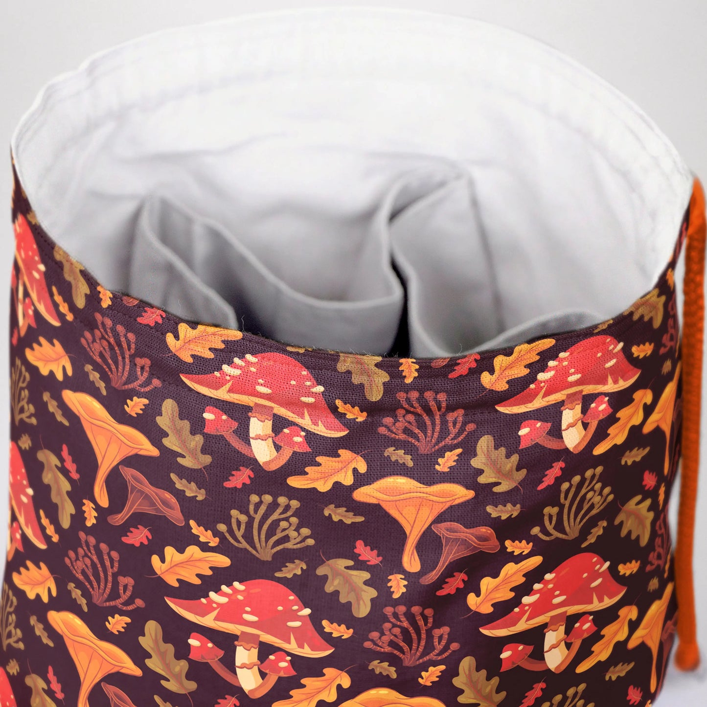 Handmade mushroom dice bag — woodland mushrooms on brown, a 6-pocket cottagecore organizer.