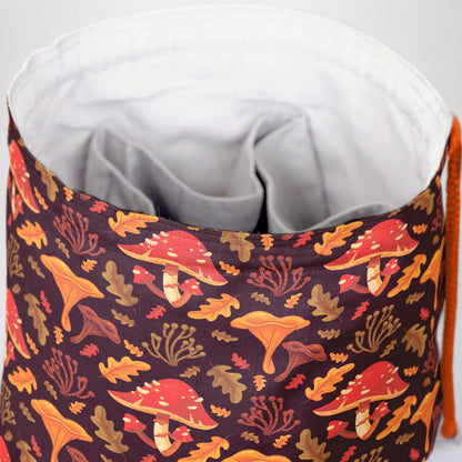 Handmade mushroom dice bag — woodland mushrooms on brown, a 6-pocket cottagecore organizer.