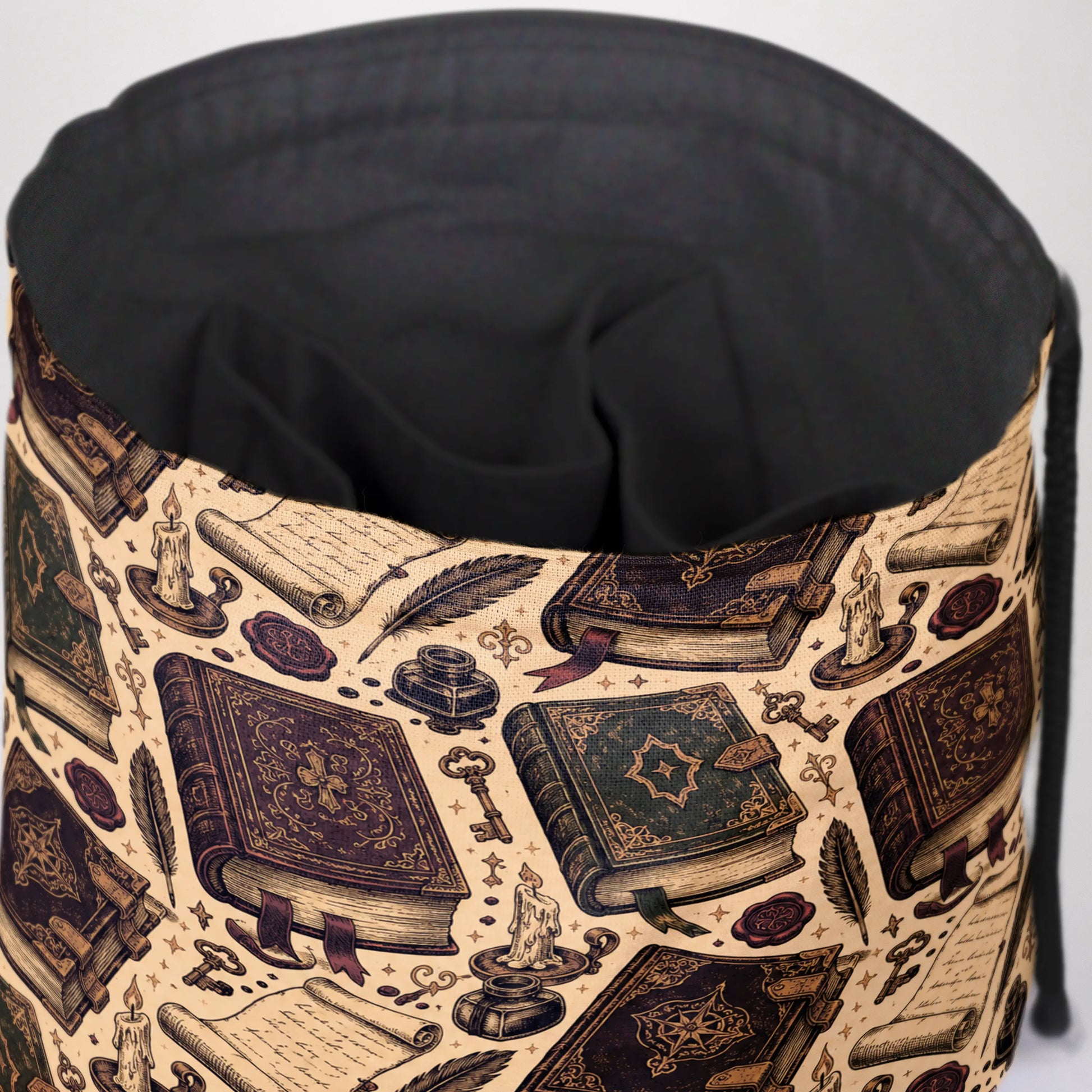 Ancient spellbook dice bag held by candlelight — handmade gabardine DnD pouch.