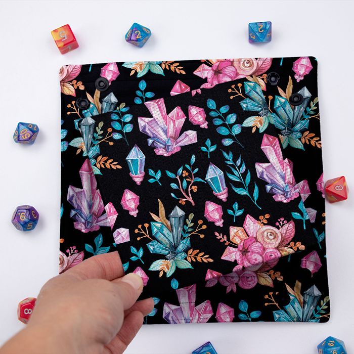 Crystal Witch dice tray folded flat, hand lifting the removable hard insert covered in the same crystal print