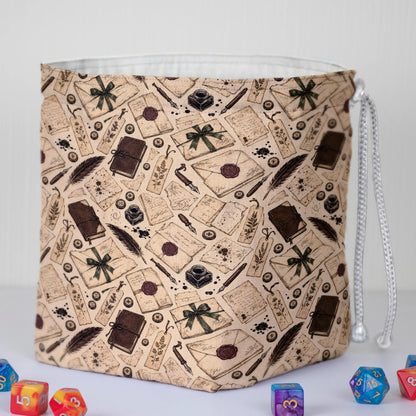 Handmade letter-print dice bag — quills, books and ribbons on cream, a 6-pocket dark academia organizer.