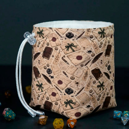 Letter Writer dice bag standing open, vintage print of sealed letters, quills, ink bottles and wax stamps, white cotton lining