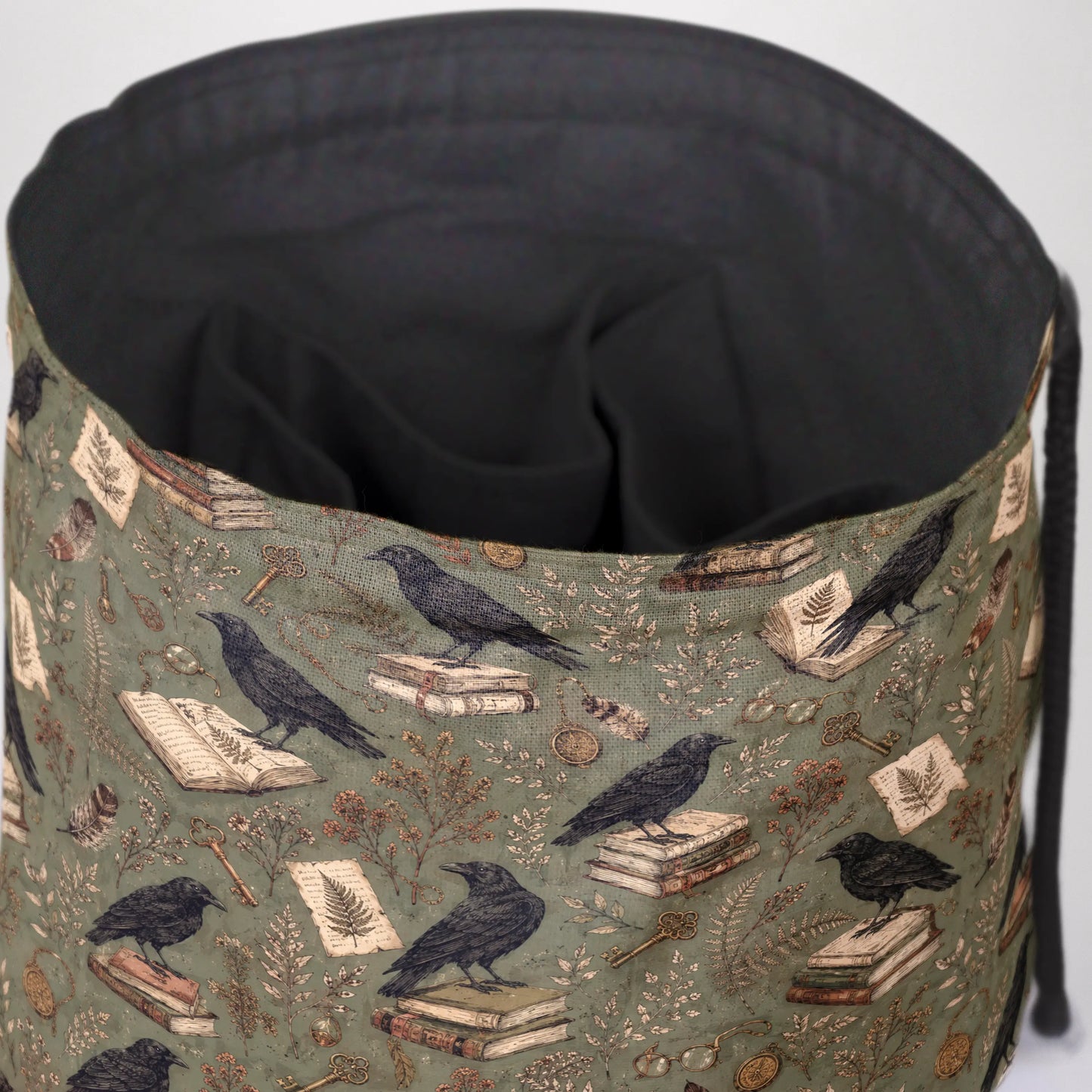 The Ravensward dice bag front view with drawstring closure — witchy dark academia DnD pouch.