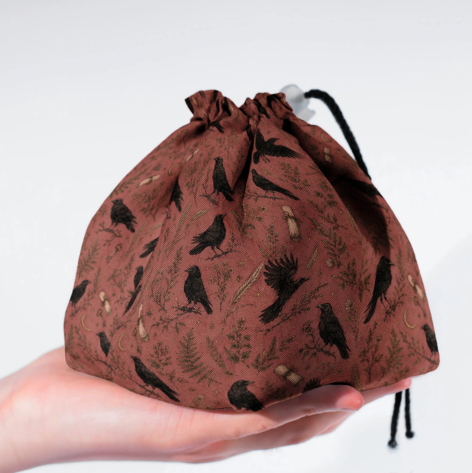 Fernwood Corvus dice bag standing upright on its square base for table-side access.