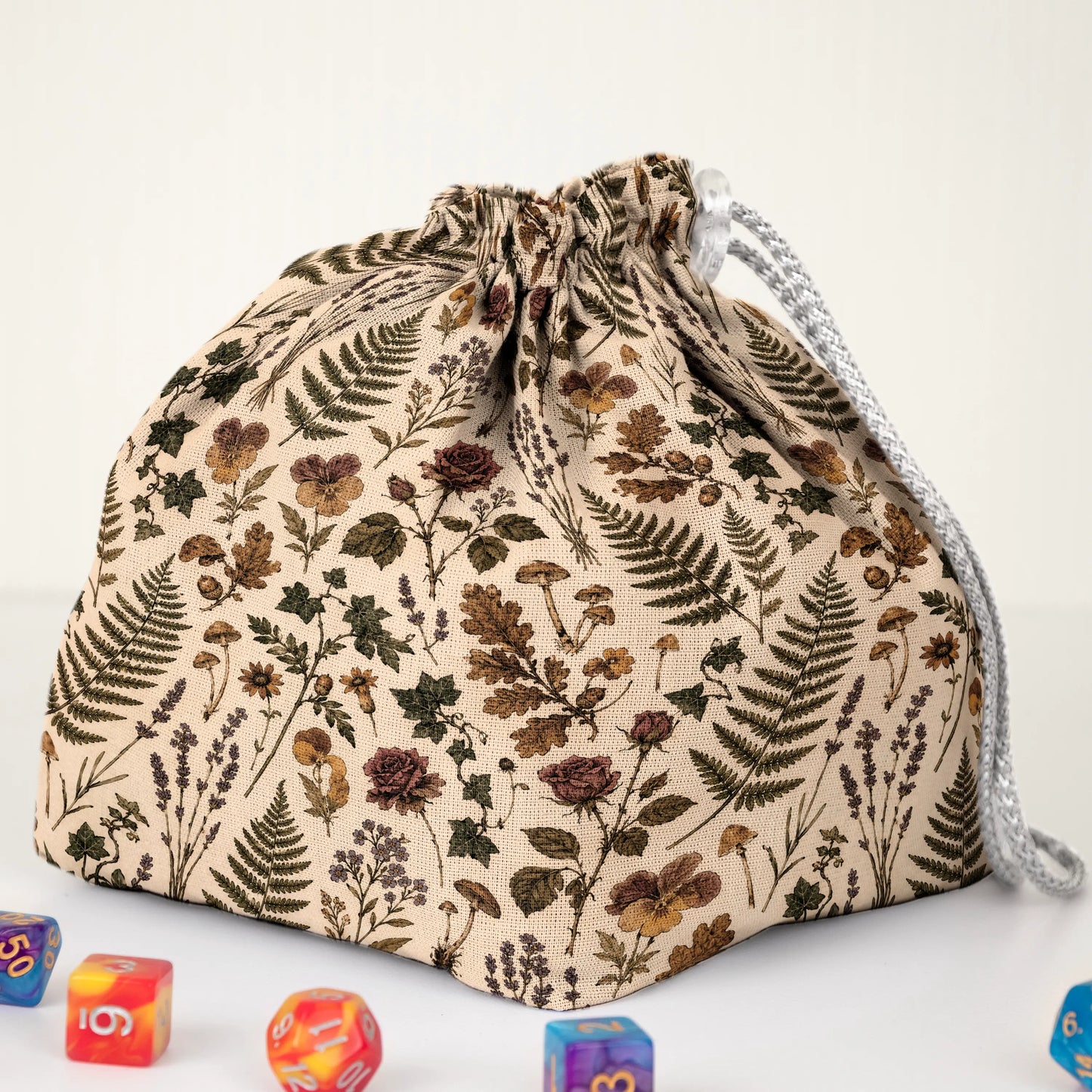 Handmade botanical dice bag — herbarium flowers and oak leaves on cream, a 6-pocket dark academia organizer.