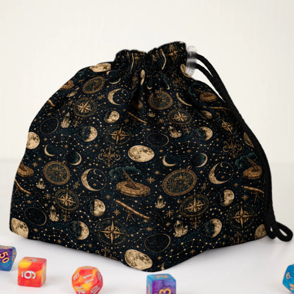 Close-up of the Celestial Almanac print — gold moon phases, compasses and stars on midnight-navy gabardine.