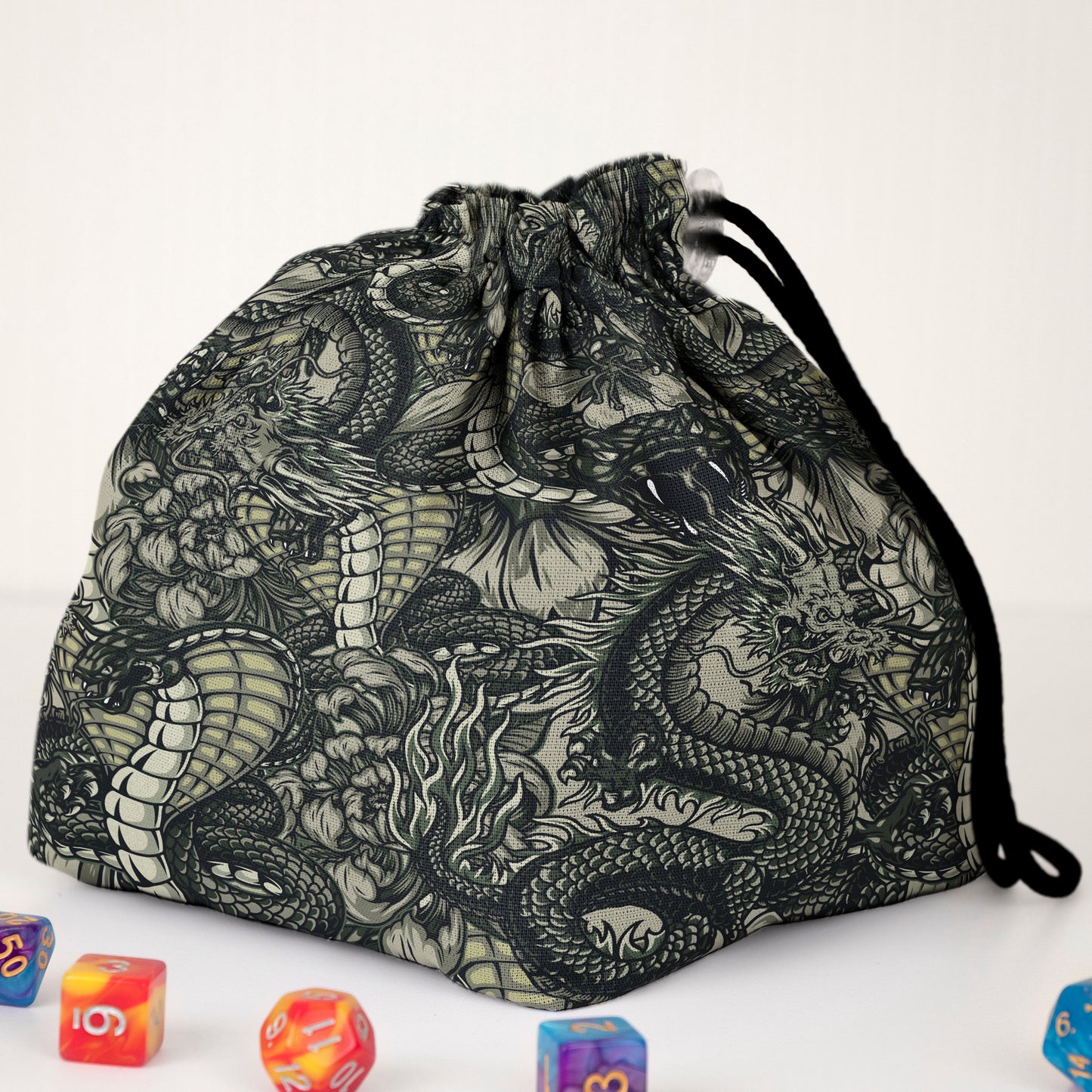 Front view of the black-and-white dragon dice bag — detailed line-art print, drawstring closure.