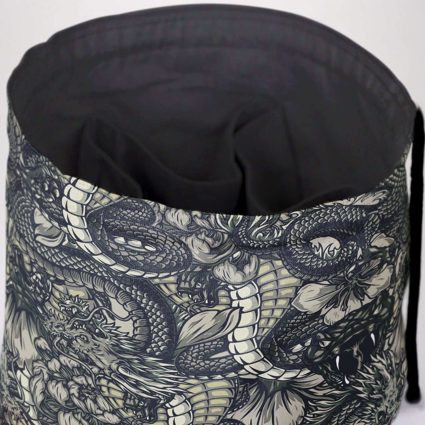 Dragon dice bag standing upright on its square base — black-and-white etched dragon art.