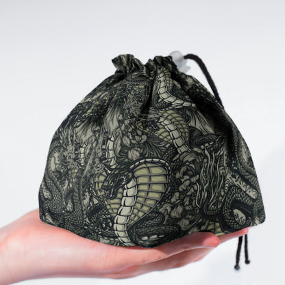 Close-up of the monochrome dragon artwork — fine line detail on gabardine fabric.