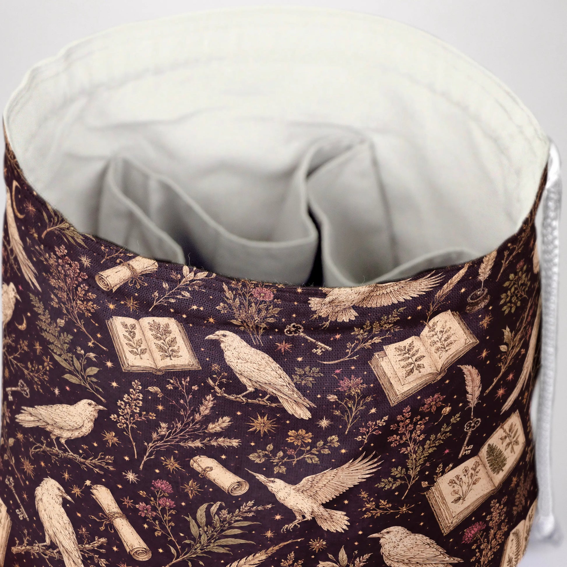 Raven's Codex dice bag front view with drawstring closure — witchy dark academia DnD pouch.
