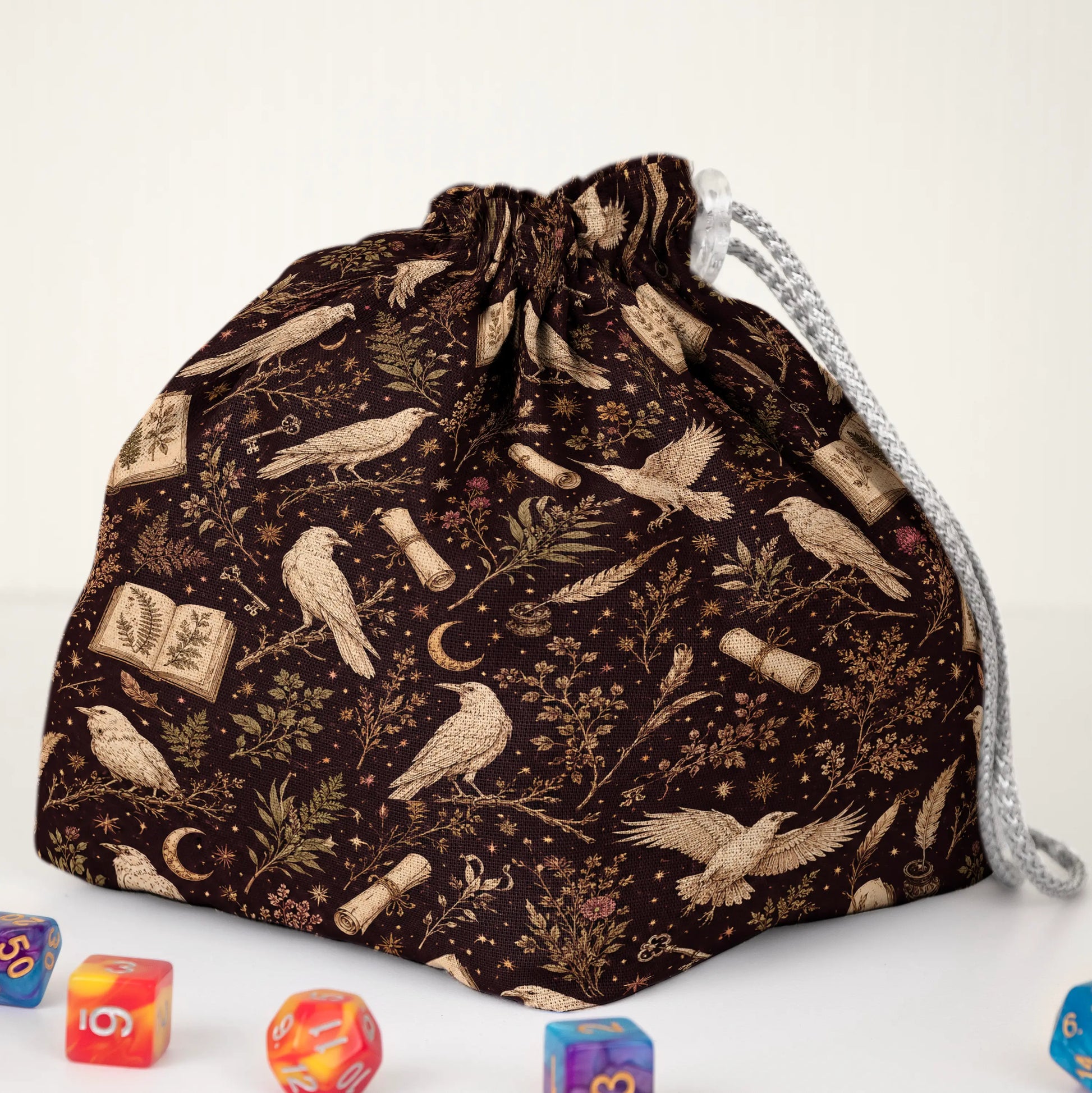 Handmade raven dice bag — books, scrolls and crescent moons on brown, a 6-pocket dark academia organizer.