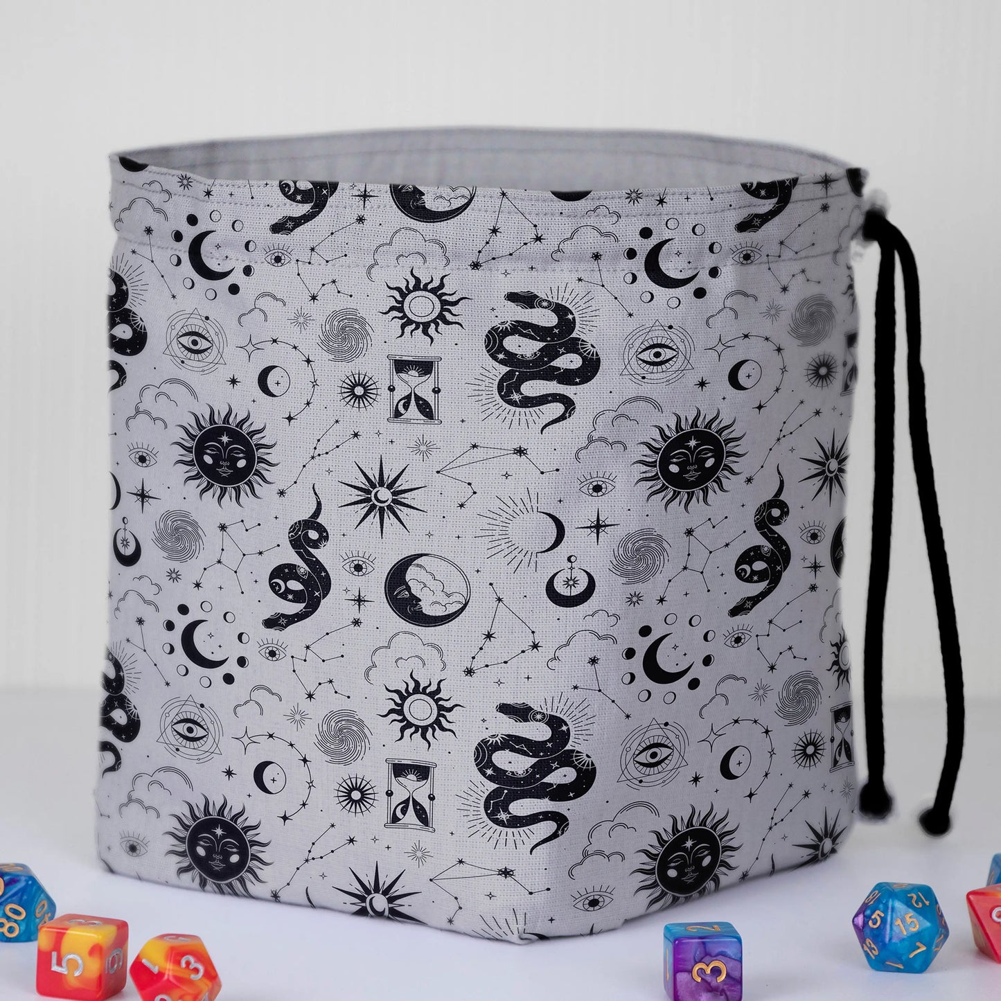 Celestial serpent witchy dice bag held in hand — handmade gabardine DnD organizer.