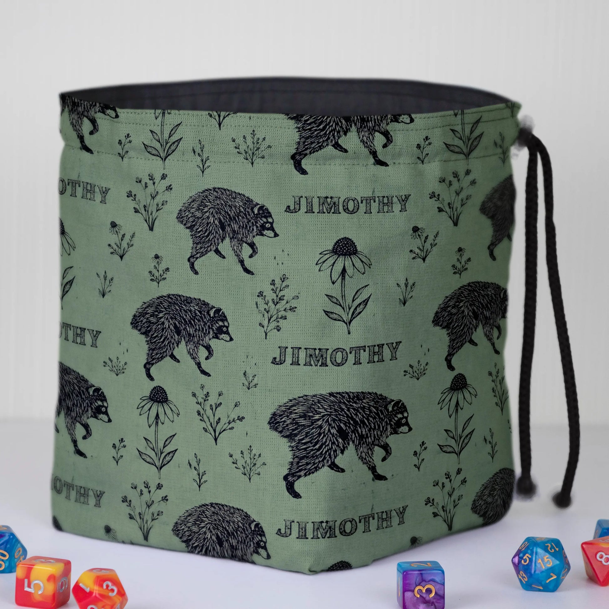 Sage botanical Jimothy dice bag standing open on its square base, dark cotton lining visible, with DnD dice