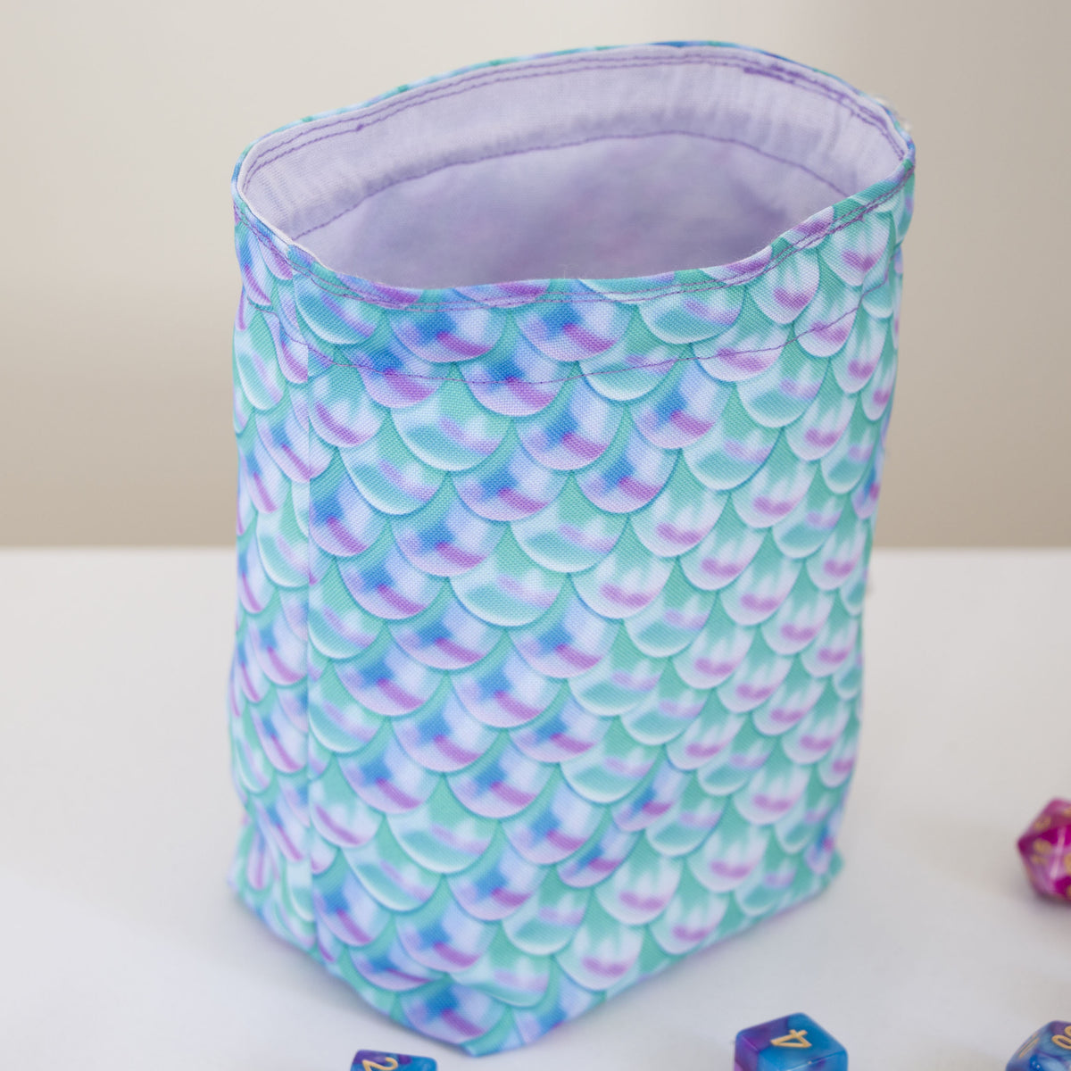 Custom dice bag open, light purple 100% cotton lining inside, mermaid scale exterior
