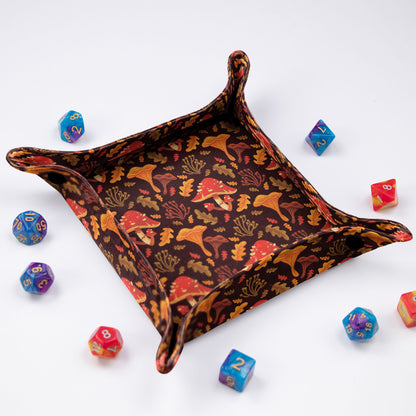 A cottagecore dice tray with autumn mushrooms and oak leaves on brown, foldable 5.5-inch surface.