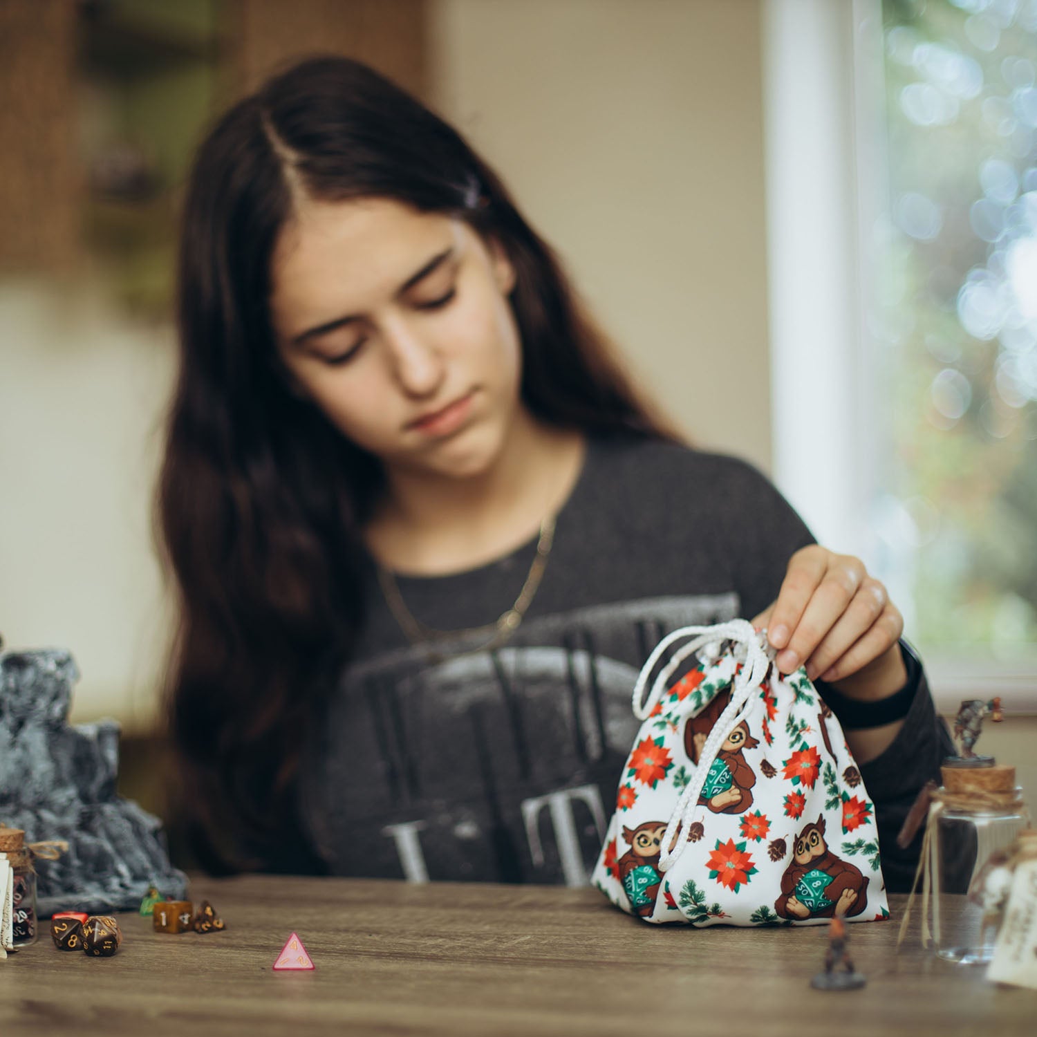 Girl using the GameFancy Dice Bag during a tabletop gaming session