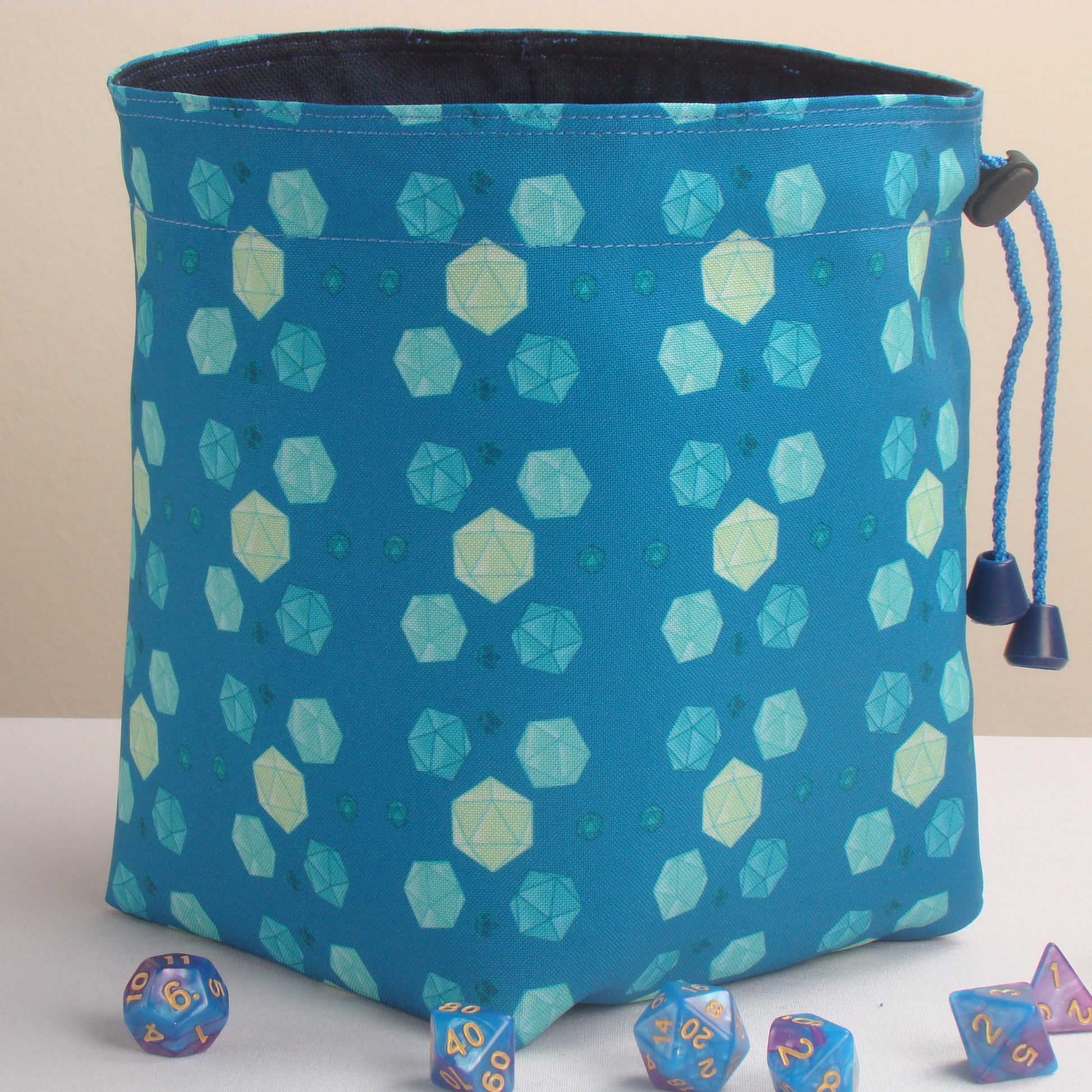 Teal dice bag with rainbow pockets for sorting dice by set.