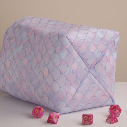 Pastel dragon-scale dice bag standing upright on its square base for table-side access.