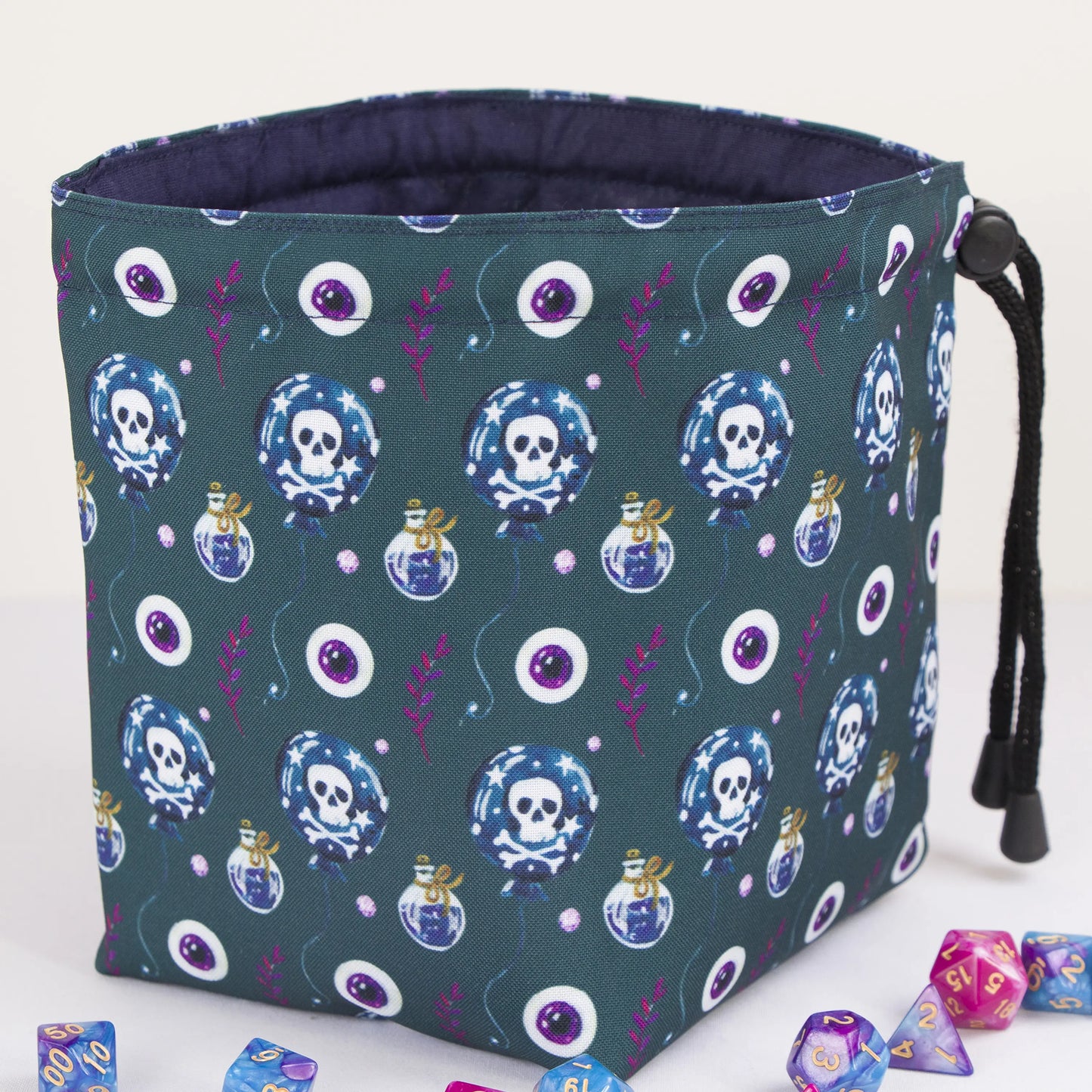 Poison and skull dice bag standing upright on its square base — witchy DnD pouch.