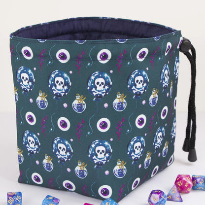 Poison and skull dice bag standing upright on its square base — witchy DnD pouch.