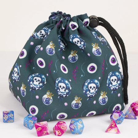 A dice bag that matches your witchy aesthetic — poison bottles, skulls and eyes on dark teal, holds 300+ dice.