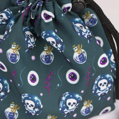 Poison and skull dice bag with 6 pockets — sorts dice sets for a witchy table.