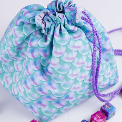 Pastel mermaid-scale dice bag with 6 pockets — sorts dice sets, aesthetic DnD organizer.