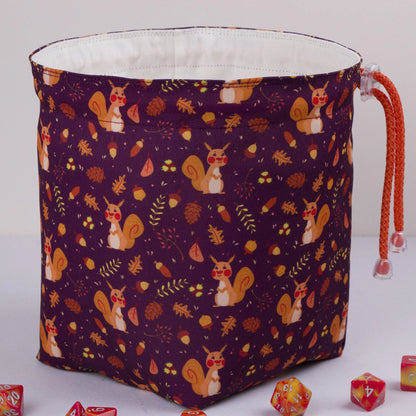 Handmade woodland dice bag — squirrels and pinecones on purple, a 6-pocket cottagecore organizer.